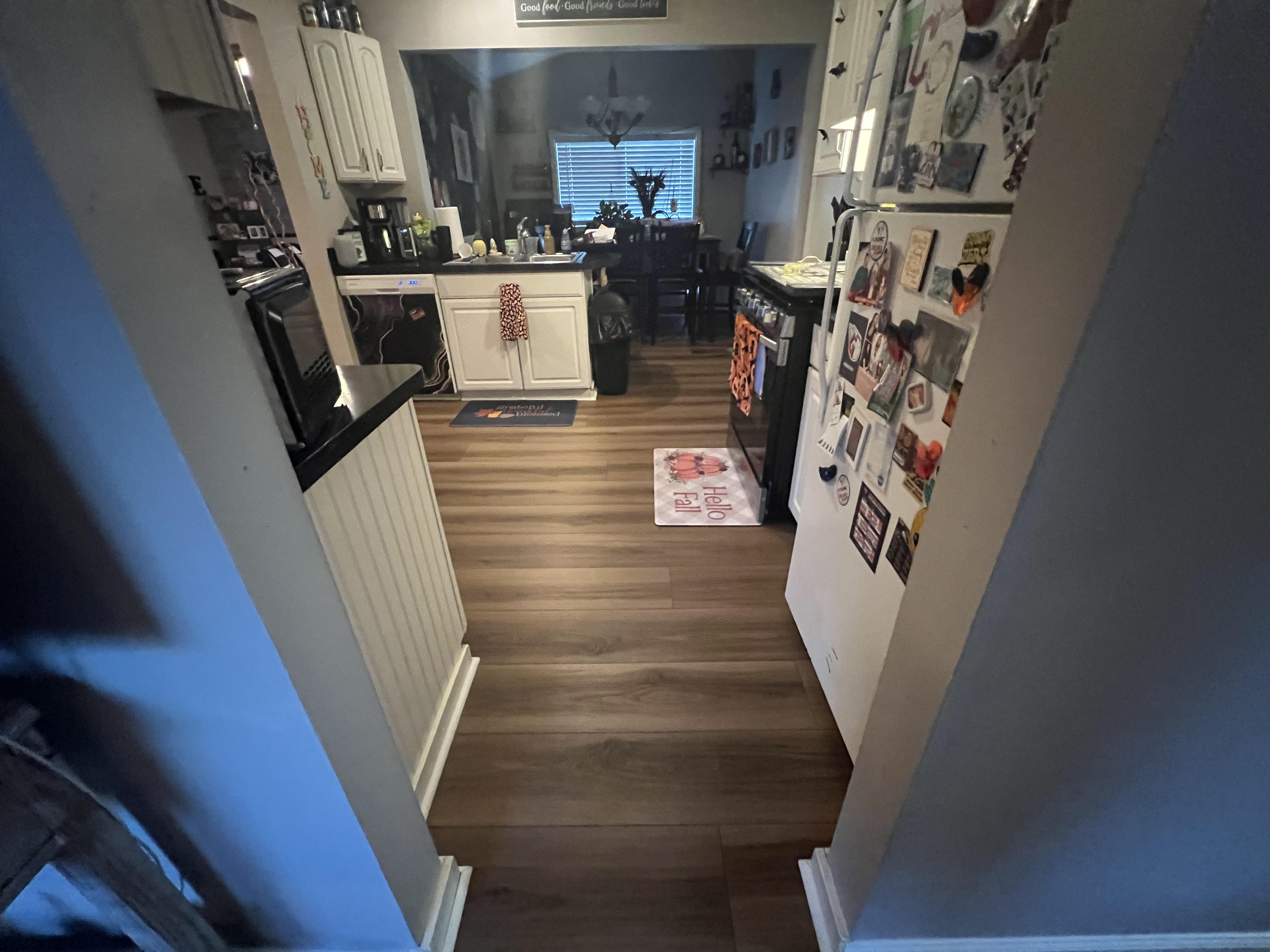 Luxury vinyl plank flooring in a Strongsville kitchen with white cabinets