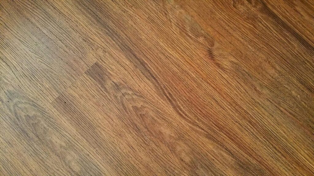 zipwp-image-218535 Detailed image of rustic wooden flooring with visible wood grain texture.
